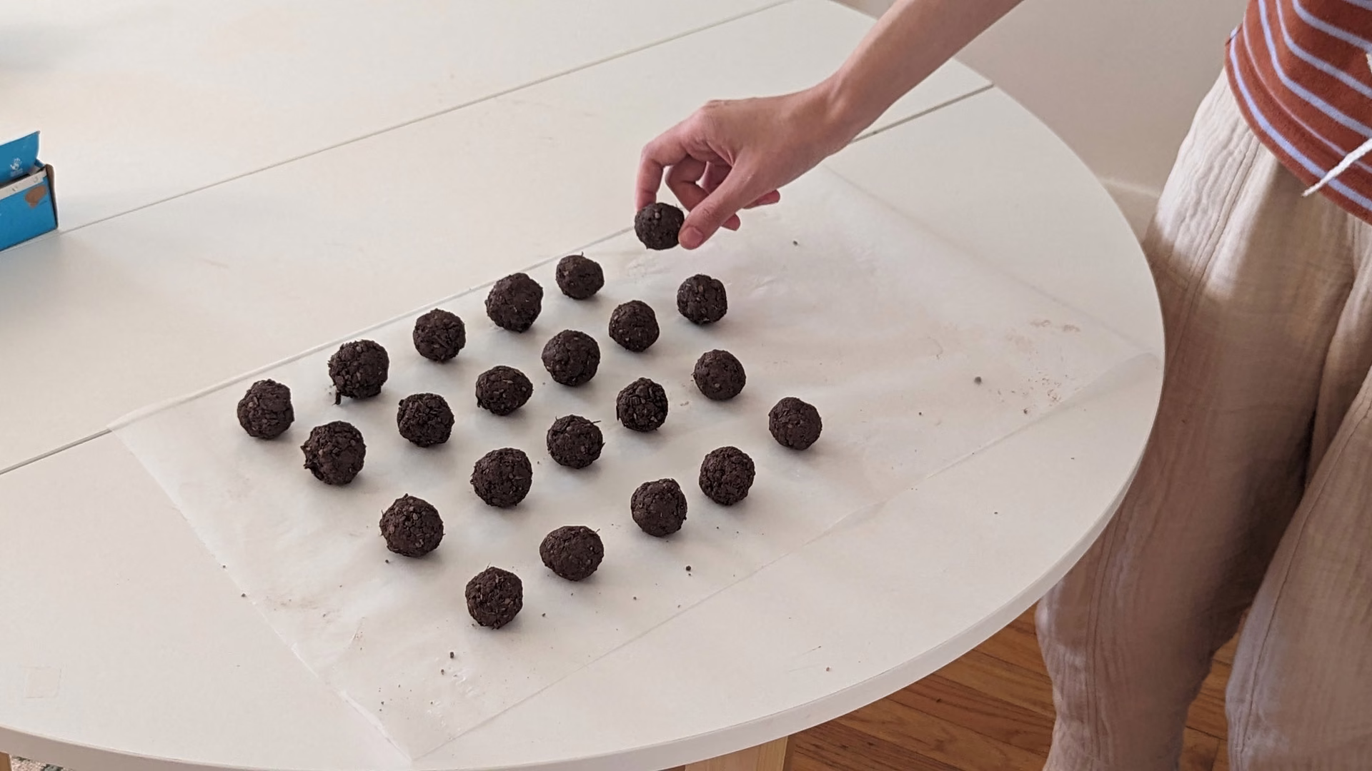 Laying rolled seed bombs out in rows to dry